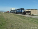 MRL 211 SD40 in front of grain elevators and warehouse